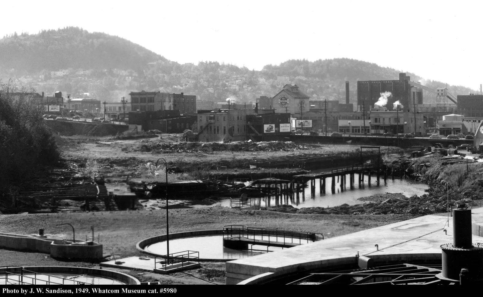 Bellingham's Holly Street dump in 1949, refuse spread across the tideflats below the downtown waterfront.